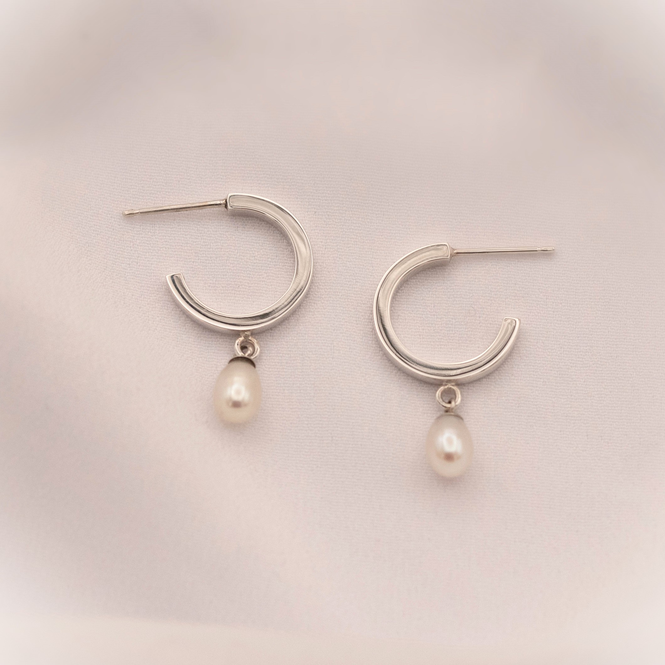 Sterling Silver & Pearl Mini Hoops Modern Pearl Mini Hoop Earrings. June birthstone jewellery, modern bridal jewellery. park Road Jewellery A versatile piece that can be worn for all occasions.